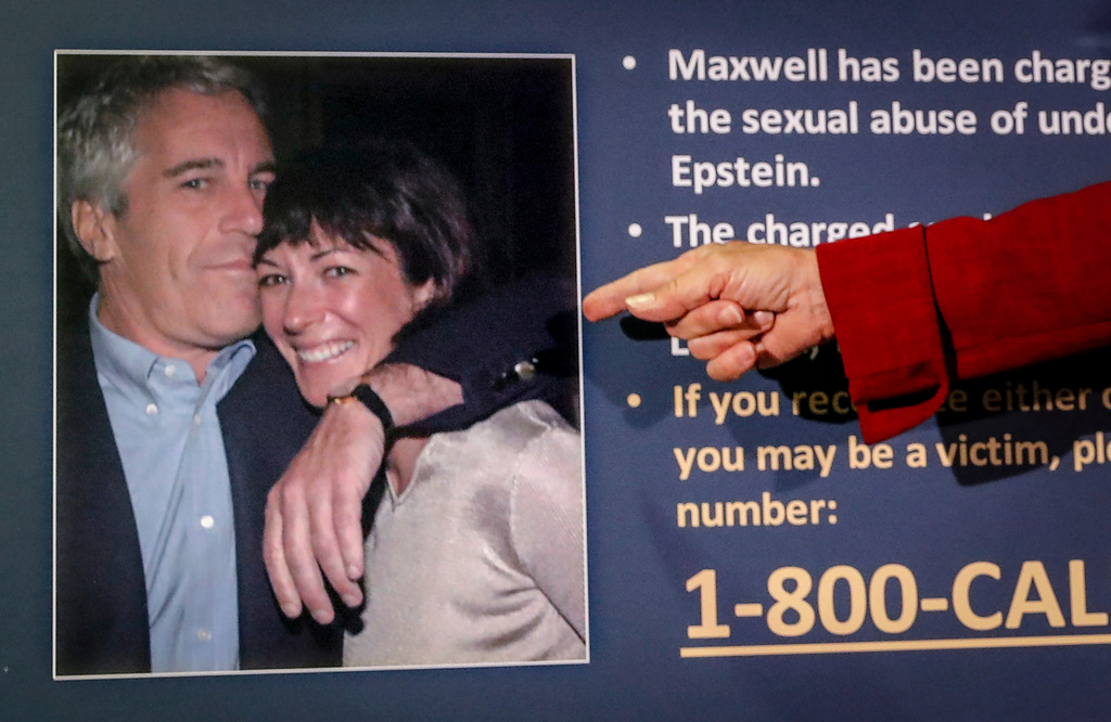 FILE - Audrey Strauss, acting U.S. attorney for the Southern District of New York, points to a photo of Jeffrey Epstein and Ghislaine Maxwell during a news conference in New York on July 2, 2020. (AP Photo/John Minchillo, File)