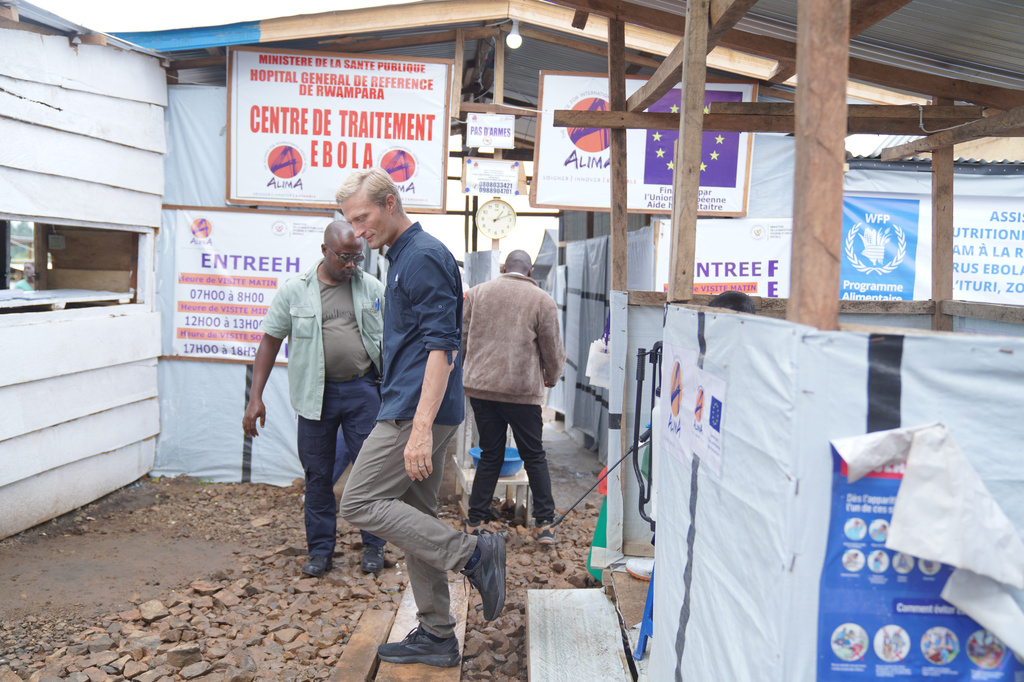 Carl Skau, acting executive director of the World Food Programme, holds up his shoe during a disinfection process at the Rwampara Ebola treatment center in Ituri, eastern Congo, Wednesday, July 29, 2026. (AP Photo/Dieudonne Dirole)