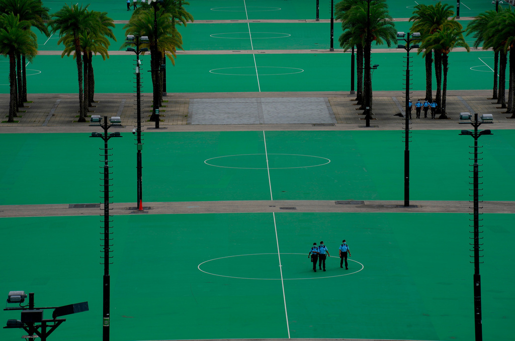 FILE - Police officers patrol an empty Hong Kong Victoria Park where in past years tens of thousands used to hold a vigil to commemorate the June 4, 1989 military crackdown in Beijing's Tiananmen Square against a pro-democracy student movement, Friday, June 4, 2021. (AP Photo/Vincent Yu, File)