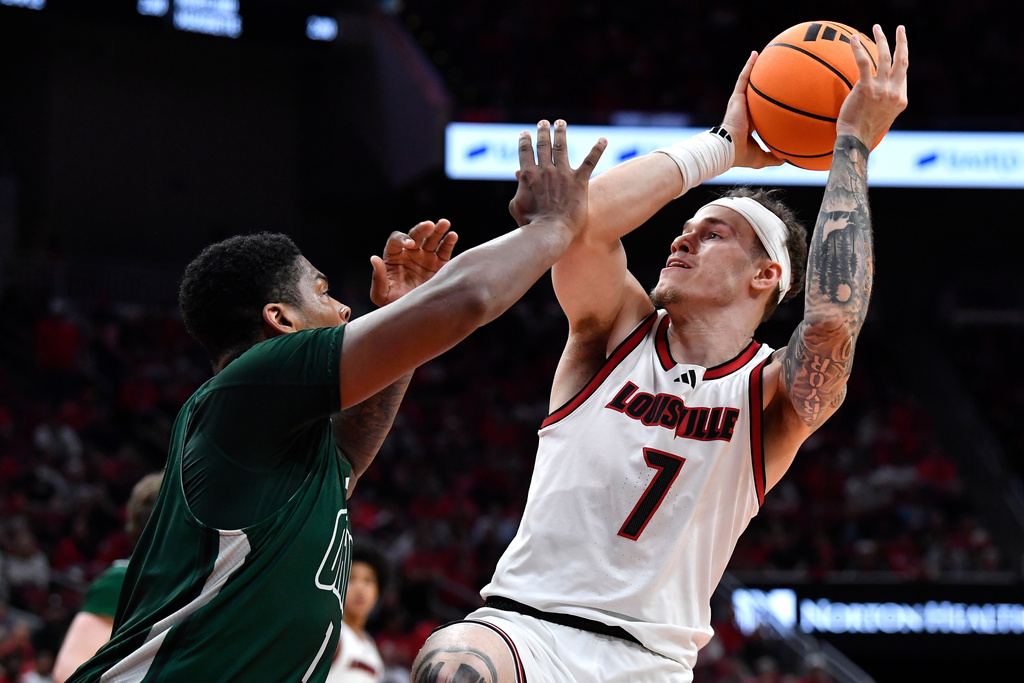 Louisville forward Kasean Pryor (7) shoots over Ohio forward Javan Simmons (1) during the second half of an NCAA college basketball game in Louisville, Ky., Saturday, Nov. 15, 2025. (AP Photo/Timothy D. Easley)