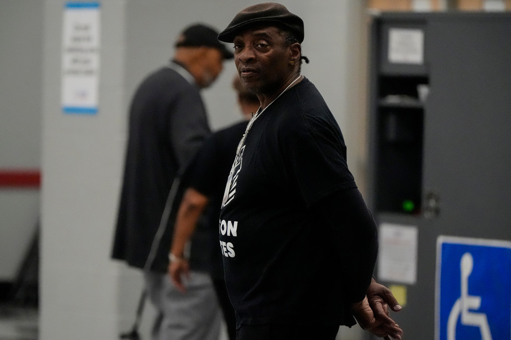 A Fulton County election worker stands as people vote in a runoff election at the C.T. Martin Recreation Center, Tuesday, June 16, 2026, in Atlanta. (AP Photo/Mike Stewart)