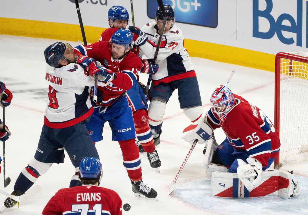 Montreal Canadiens goaltender Sam Montembeault (35) keeps an eye on the puck as Canadiens' Josh Anderson (17) defends against Washington Capitals' Alex Ovechkin (8) in front of the net during first period NHL hockey action in Montreal on Thursday, Nov. 20, 2025. (Christinne Muschi/The Canadian Press via AP)