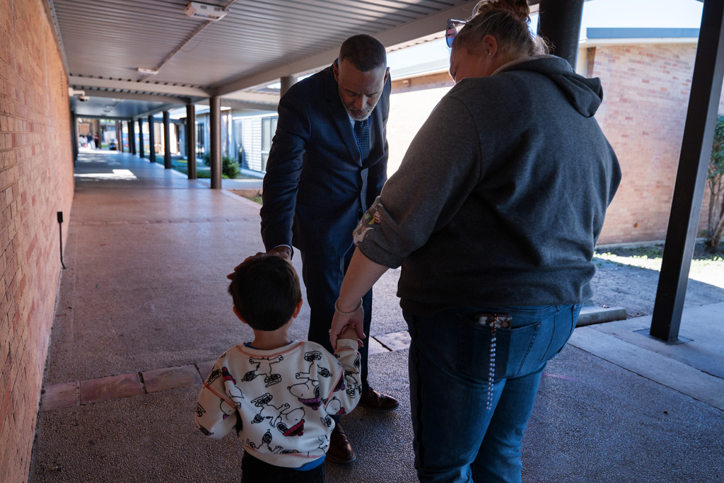 Lackland Independent School District Superintendent Dr. Burnie Roper checks on a student while walking around the campus Monday, Nov. 3, 2025, in San Antonio. (AP Photo/Kin Man Hui)
