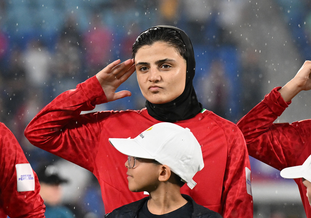 Iran women's soccer player Fatemeh Pasandideh salutes during the national anthem of Iran prior to the AFC Women's Asian Cup Group A match against the Philippines at Gold Coast Stadium on the Gold Coast, Australia, Sunday, March 8, 2026. (Dave Hunt/AAP Image via AP)