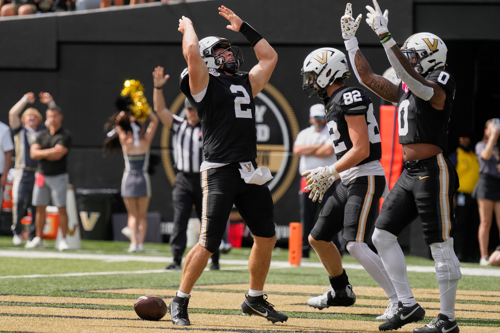 Vanderbilt quarterback Diego Pavia (2) celebrates his touchdown with wide receiver Junior Sherrill (0) during the first half of an NCAA college football game against Utah State, Saturday, Sept. 27, 2025, in Nashville, Tenn. (AP Photo/George Walker IV)