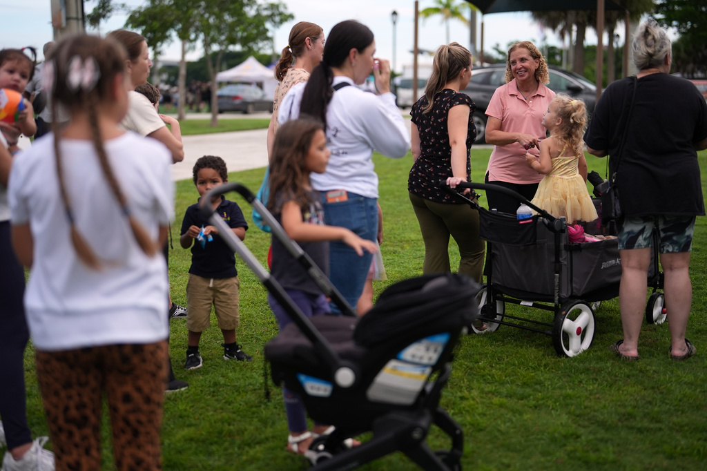 U.S. Rep. Debbie Wasserman Schultz, third from right, greets constituents at a National Night Out community event while campaigning for Florida's 20th congressional district, in Plantation, Fla., Tuesday, Aug. 4, 2026. (AP Photo/Rebecca Blackwell).