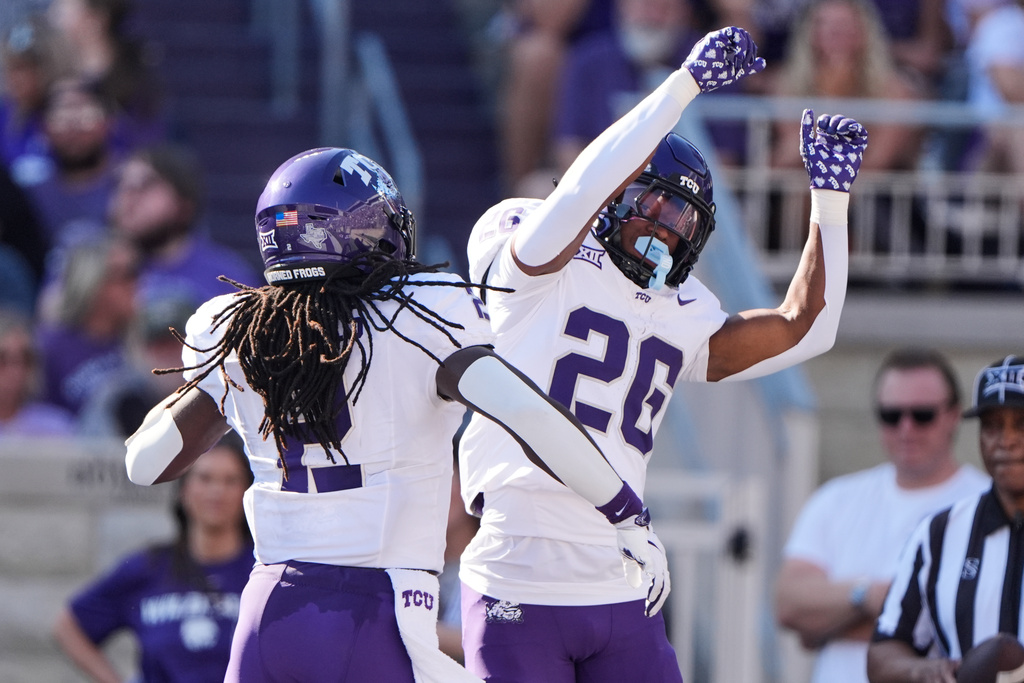 TCU running back Jeremy Payne (26) celebrates with running back Kevorian Barnes (2) after scoring a touchdown during the first half of an NCAA college football game against Kansas State, Saturday, Oct. 11, 2025, in Manhattan, Kan. (AP Photo/Charlie Riedel)