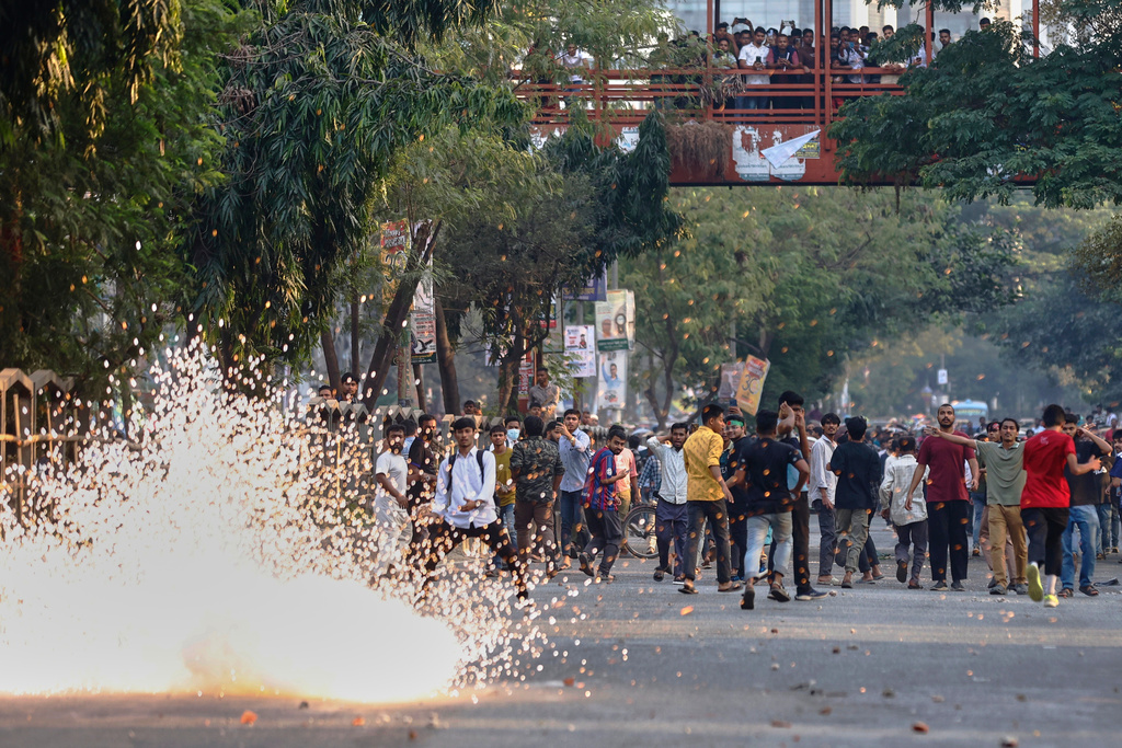 Police use stun grenades to disperse protesters gathering outside the demolished residence of Sheikh Mujibur Rahman, Bangladesh's former leader and the father of the country's ousted Prime Minister Sheikh Hasina following the verdict against her, in Dhaka, Bangladesh, Monday, Nov. 17, 2025. (AP Photo/ Rajib Dhar)