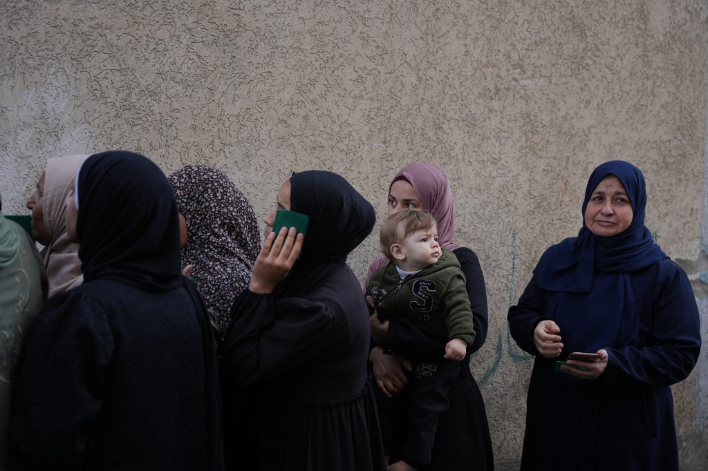 Palestinian women line up in front of a polling station to vote for local elections, the first in two decades in Gaza and the first in the occupied West Bank since the start of the Israel-Hamas war in Deir al-Balah, central Gaza Strip, Saturday, April 25, 2026. (AP Photo/Abdel Kareem Hana)