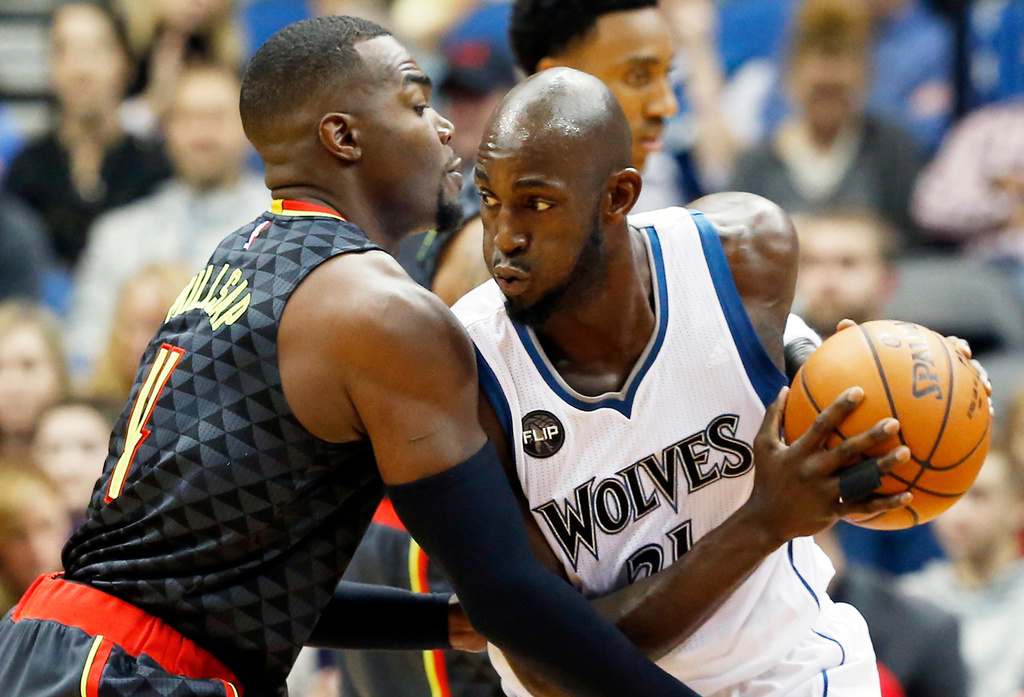 FILE - Minnesota Timberwolves' Kevin Garnett, right, drives against Atlanta Hawks' Paul Millsap in the first quarter of an NBA basketball game in Minneapolis, Nov. 25, 2015. (AP Photo/Jim Mone, File)