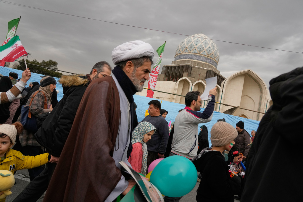 A cleric and other people attend an annual rally marking 1979 Islamic Revolution in Tehran, Iran, Wednesday, Feb. 11, 2026. (AP Photo/Vahid Salemi)