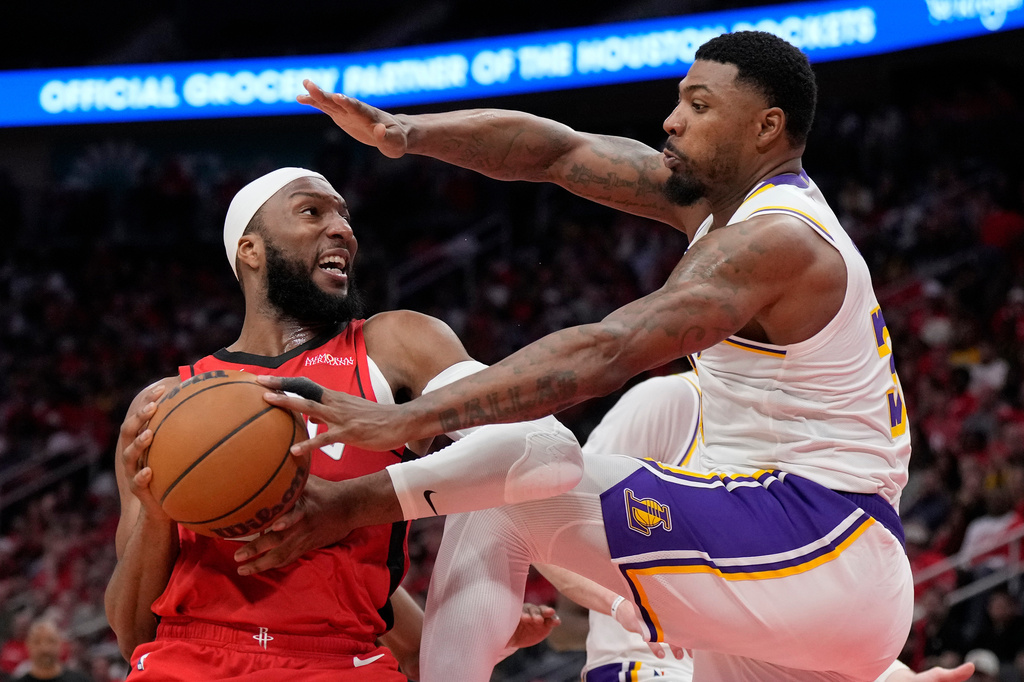 FILE - Houston Rockets guard Josh Okogie, left, controls the ball against Los Angeles Lakers guard Marcus Smart, right, during the second half in Game 4 of a first-round NBA basketball playoffs series, April 26, 2026, in Houston. (AP Photo/Karen Warren, File)