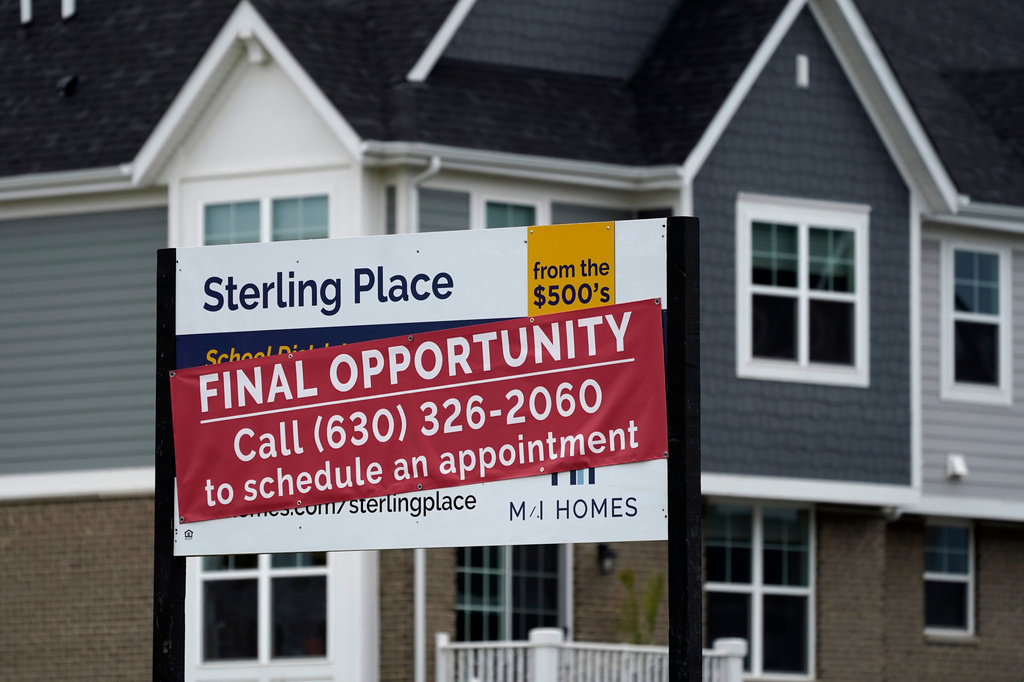 FILE - An advertising sign for building land stands in front of a new home construction site in Northbrook, Ill., on May 5, 2022. (AP Photo/Nam Y. Huh, File)