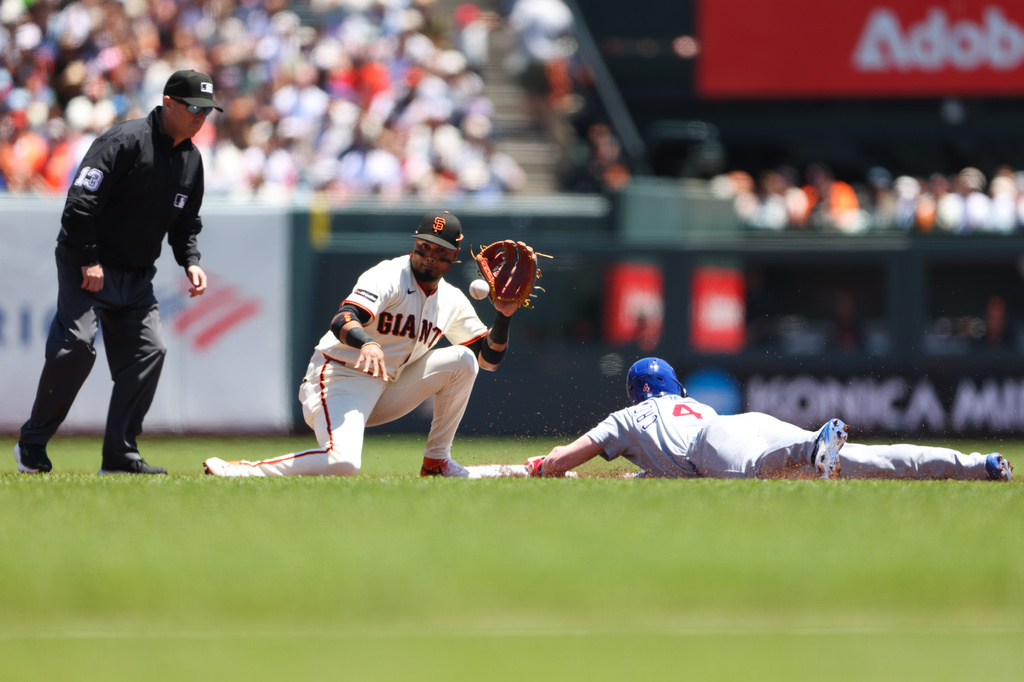 Chicago Cubs' Pete Crow-Armstrong (4) steals second base ahead of a tag by San Francisco Giants second baseman Luis Arraez, second from left, during the third inning of a baseball game Sunday, June 14, 2026, in San Francisco. (AP Photo/Scott Marshall)