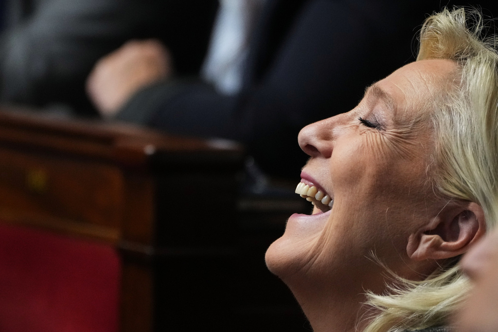French far-right leader Marine Le Pen reacts as French Prime Minister Sebastien Lecornu delivers his policy speech at the National Assembly, Tuesday, Oct. 14, 2025 in Paris. (AP Photo/Thibault Camus)