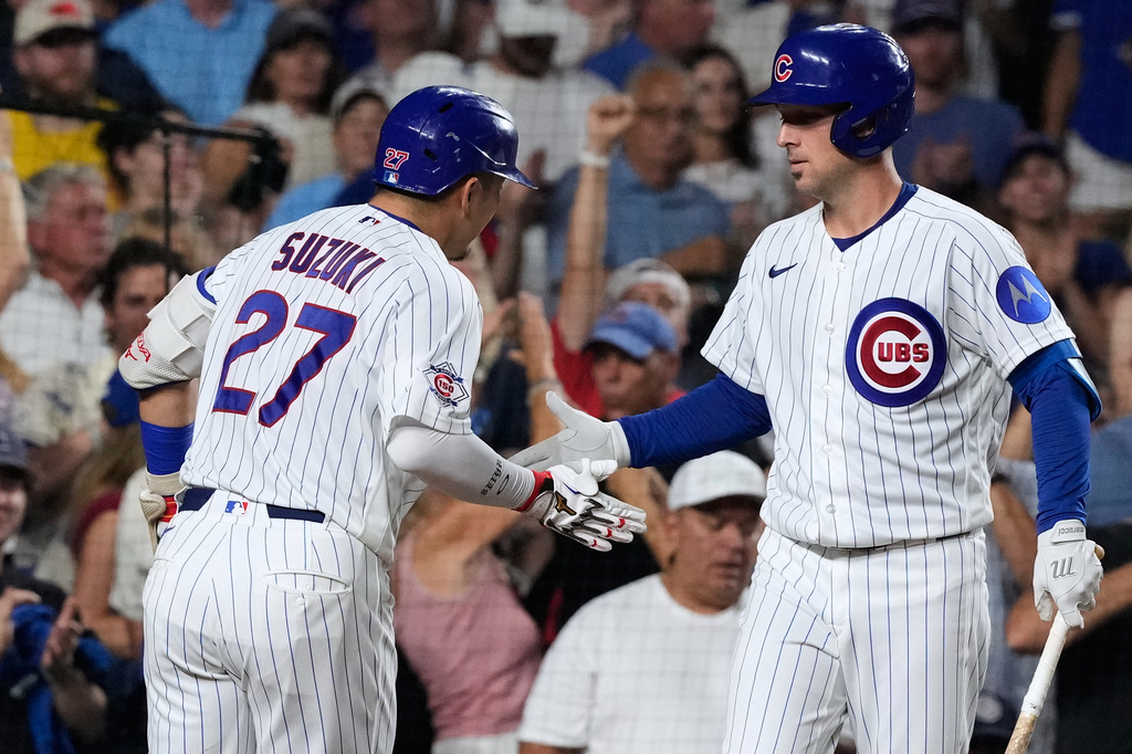 Chicago Cubs' Seiya Suzuki, left, of Japan, is congratulated by Alex Bregman, right, after hitting a solo home run during the fourth inning of a baseball game against the Milwaukee Brewers in Chicago, Monday, Aug. 31, 2026. (AP Photo/Nam Y. Huh)