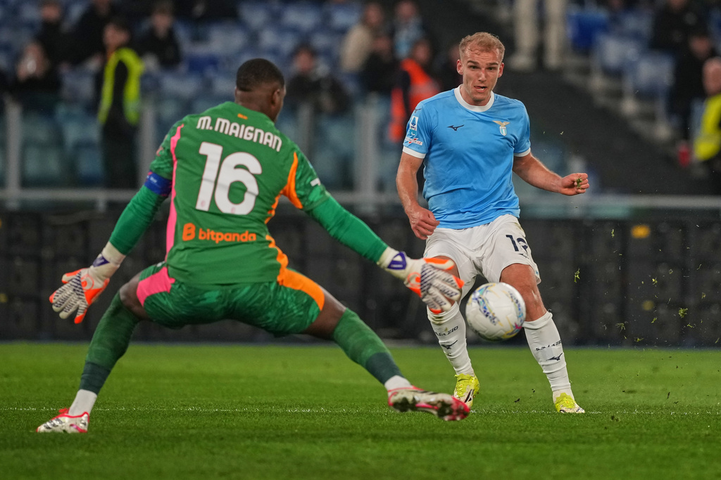 Lazio's Gustav Isaksen scores his side's opening goal past AC Milan's goalkeeper Mike Maignan during a Serie A soccer match between Lazio and Milan, in Rome, Sunday, March 15, 2026. (AP Photo/Andrew Medichini)