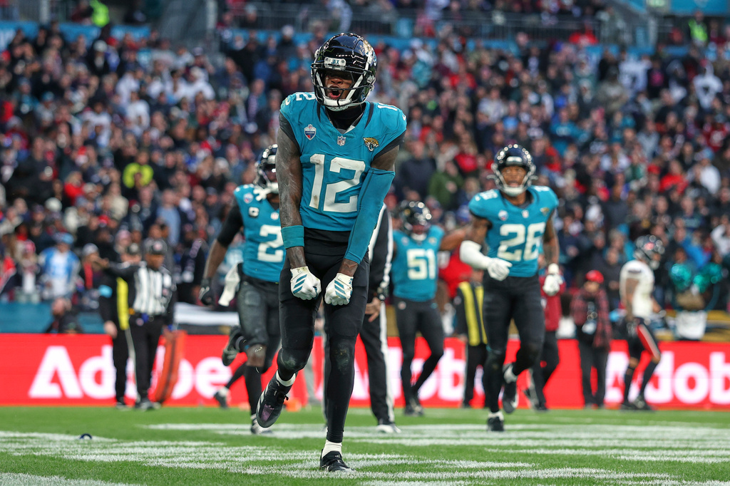 Jacksonville Jaguars wide receiver Travis Hunter (12) celebrates after making an interception during an NFL football game against Houston Texans in London, Sunday, Oct. 18, 2026. (AP Photo/Ian Walton)
