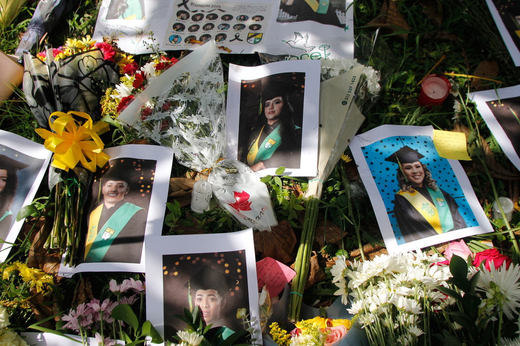 An improvised altar with photos of students stands outside Antioqueño High School in Medellín, Colombia, Monday, Dec. 15, 2025, a day after a bus carrying students returning from a trip crashed, killing multiple passengers. (AP Photo/Miguel Angel Lopez)