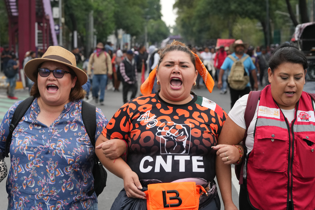 Striking teachers march toward the stadium that will host the opening match of the FIFA World Cup in Mexico City, Tuesday, June 9, 2026. (AP Photo/Eduardo Verdugo)