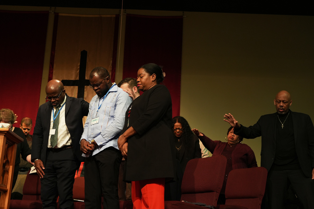 Faith leaders and Haitian community leaders pray at St. John Missionary Baptist Church in Springfield, Ohio, Monday, Feb. 2, 2026, during an event in support of Haitian migrants fearing the end of their Temporary Protected Status in the U.S. (AP Photo/Luis Andres Henao)