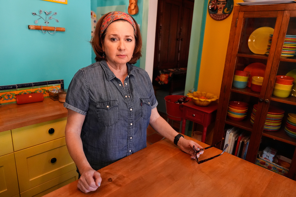 Gigi Cervantes, who resigned from her position as a theater teacher at a Fort Worth school rather than teach in a classroom where the Ten Commandments are hung, poses for a photo at her home, Wednesday, Nov. 5, 2025, in Fort Worth, Texas. (AP Photo/Tony Gutierrez)
