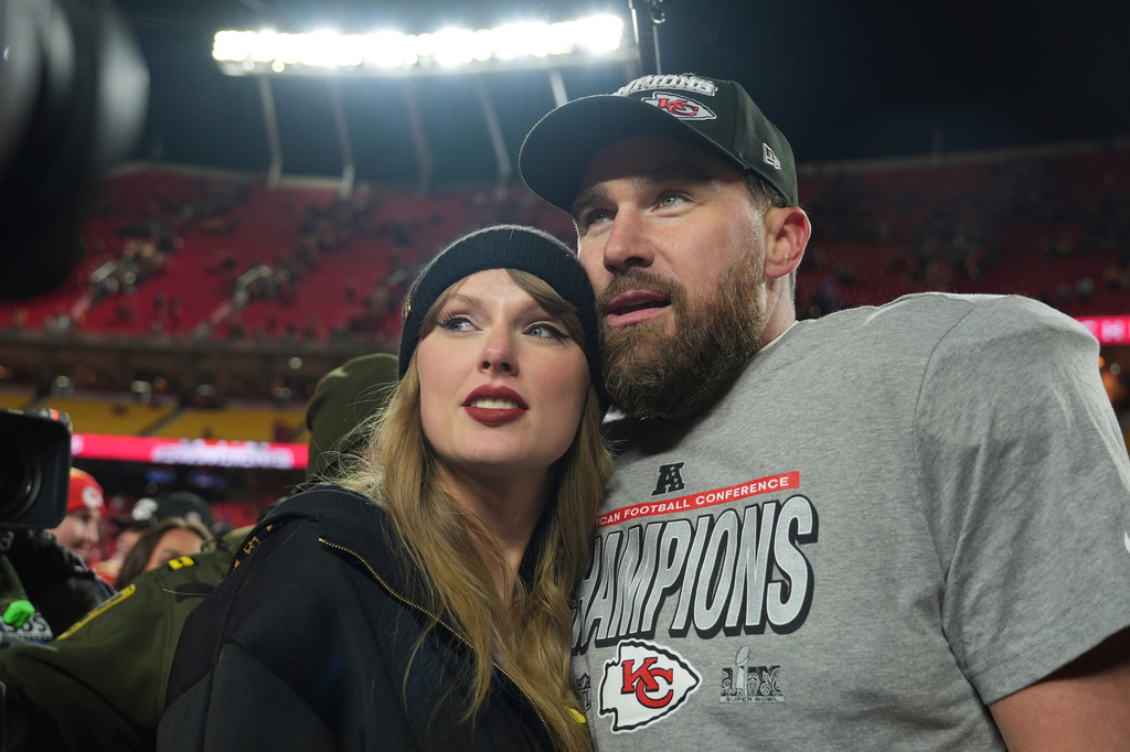 FILE - Kansas City Chiefs tight end Travis Kelce, right, is congratulated by Taylor Swift as they celebrate the Chiefs' victory over the Buffalo Bills in the AFC Championship NFL football game, Jan. 26, 2025, in Kansas City, Mo. (AP Photo/Charlie Riedel, File)