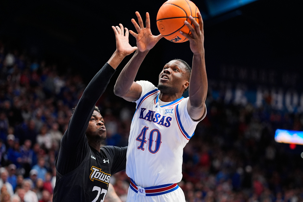 Kansas forward Flory Bidunga (40) shoots over Towson forward Caleb Embeya (23) during the first half of an NCAA college basketball game Tuesday, Dec. 16, 2025, in Lawrence, Kan. (AP Photo/Charlie Riedel)