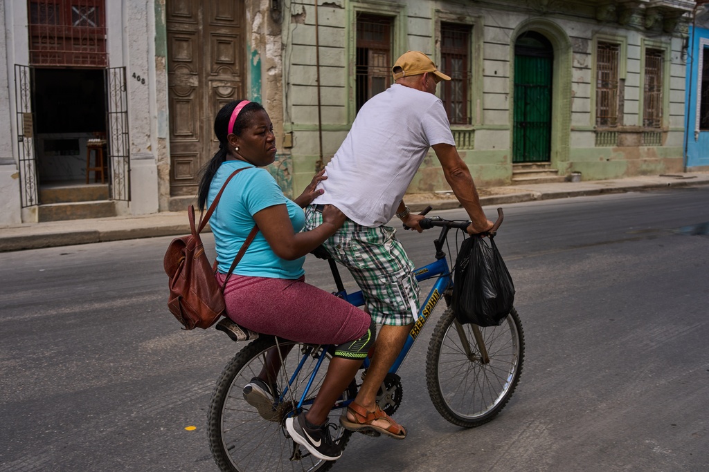 People ride a bicycle during a blackout in Havana, Cuba, Monday, March 16, 2026. (AP Photo/Ramon Espinosa)