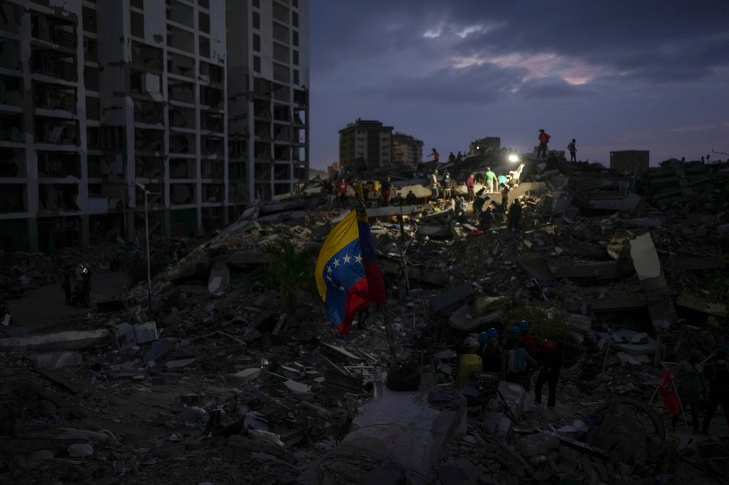 Residents and rescue workers search through the rubble of buildings damaged in the earthquakes that struck La Guaira, Venezuela, Thursday, July 2, 2026. (AP Photo/Matias Delacroix)