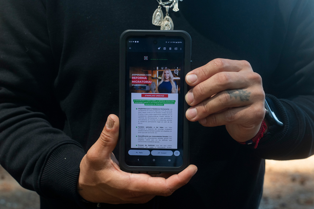 Gabriel Martinez Garcia, 30, poses with an email advertisement from attorney Lozano displayed on his phone in Tenino, Wash., on Sunday, June 14, 2026. . (AP Photo/Akash Pamarthy)