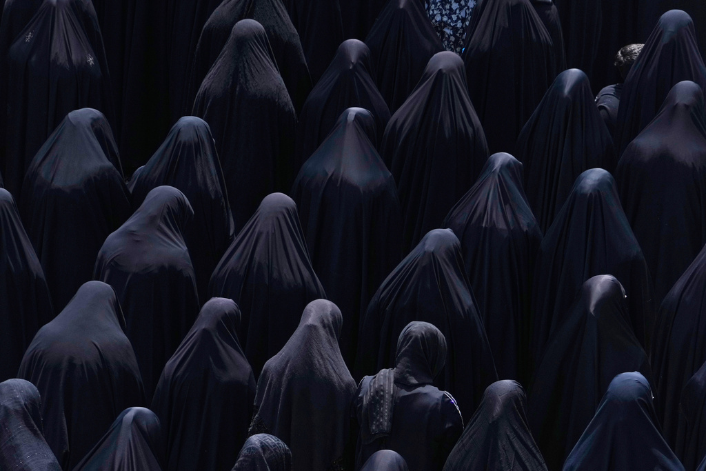 Shiite Muslim women pray at the shrine of Saint Abdulazim in Shahr-e-Ray, south of Tehran, Iran, Thursday, Aug. 14, 2025, during a ceremony to observe the Arbaeen, which marks the anniversary of the 40th day of mourning following the 7th century death of the Prophet Muhammad's grandson Hussein, who was killed in a battle in Karbala in present-day Iraq. (AP Photo/Vahid Salemi)