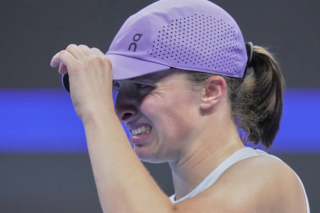 Iga Swiatek, of Poland reacts during the women's singles match against Emma Navarro, of the United States, in the China Open tennis tournament, at the National Tennis Center, in Beijing, Wednesday, Oct. 1, 2025. (AP Photo/Andy Wong)
