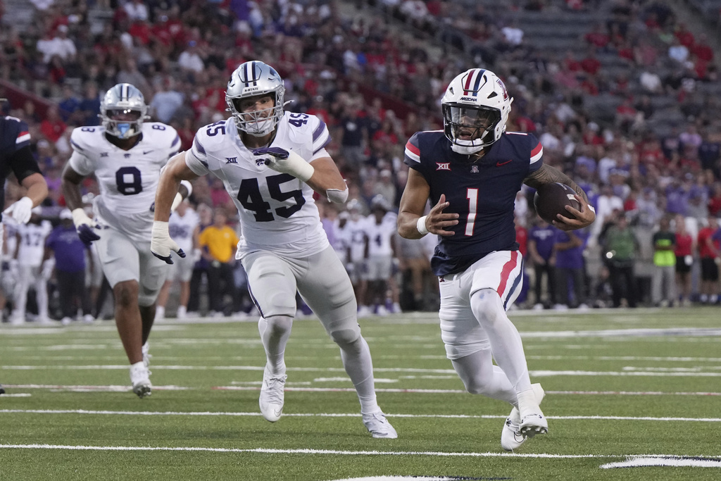 Arizona quarterback Noah Fifita runs for a touchdown in front of Kansas State linebacker Austin Romaine (45) in the first half of an NCAA college football game, Friday, Sept 12, 2025, in Tucson, Ariz. (AP Photo/Rick Scuteri)