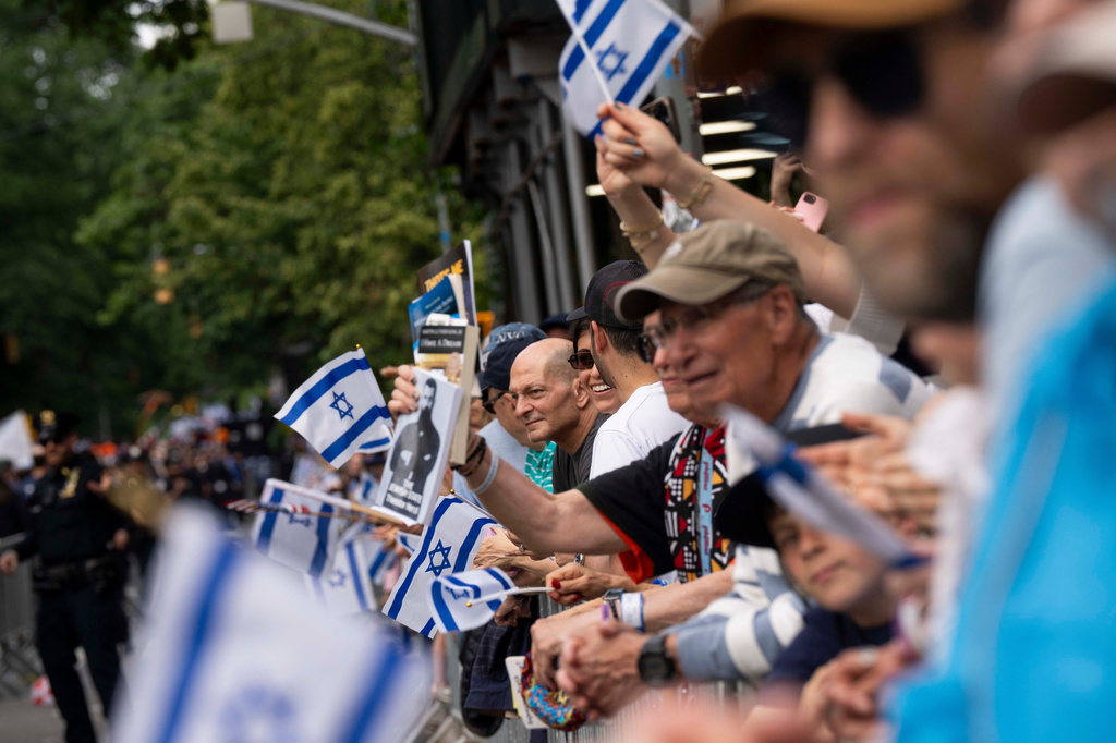Spectators wave flags during the Israel Day Parade, Sunday, May 31, 2026, in New York. (AP Photo/Emil T. Lippe)