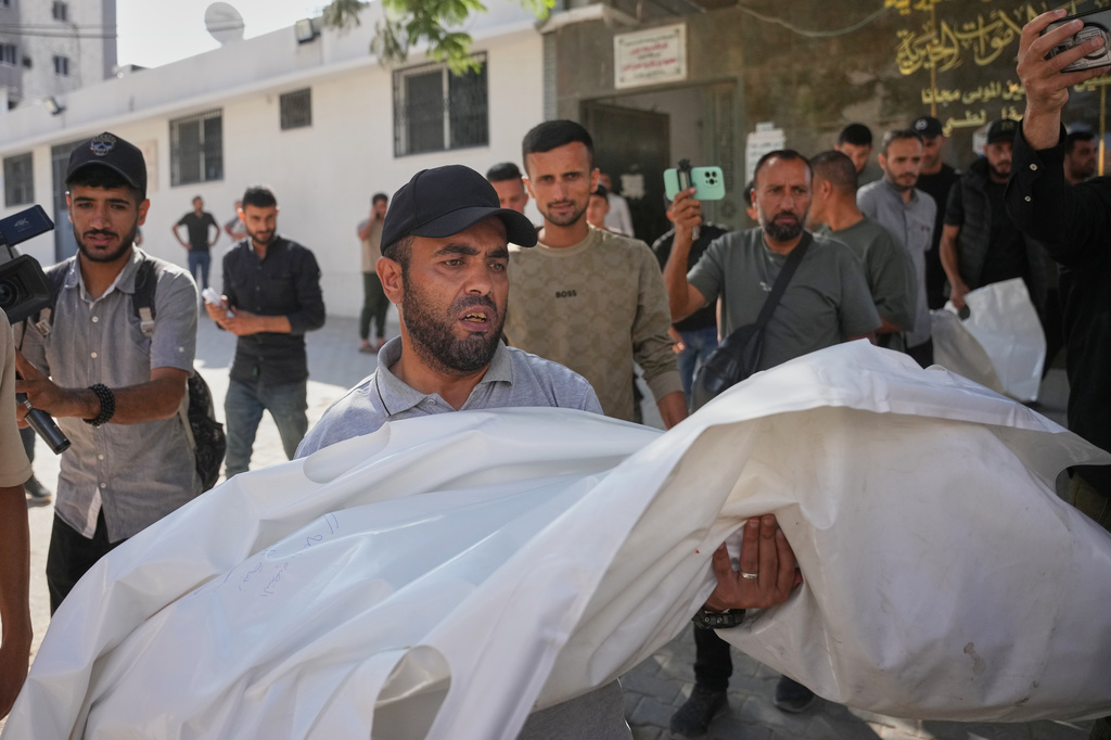Mourners carry the bodies of two Palestinian girls Zeina Safadi, and her sister Lana, who were killed during an overnight Israeli airstrike that damaged their home, during their funeral in Gaza city, Saturday, June 20, 2026. (AP Photo/Abdel Kareem Hana)