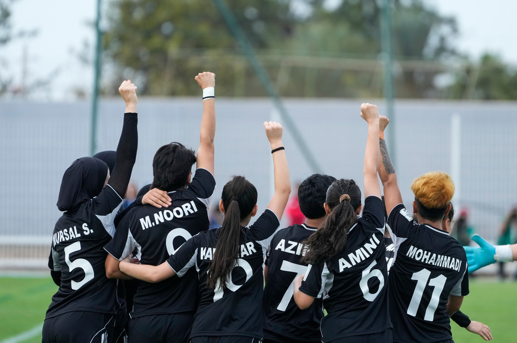 Members of Afghan Women United soccer team celebrate after scoring a goal against Chad, in their first international tournament since fleeing their country, in Casablanca, Morocco, Sunday, Oct. 26, 2025. (AP Photo/Mosa'ab Elshamy)