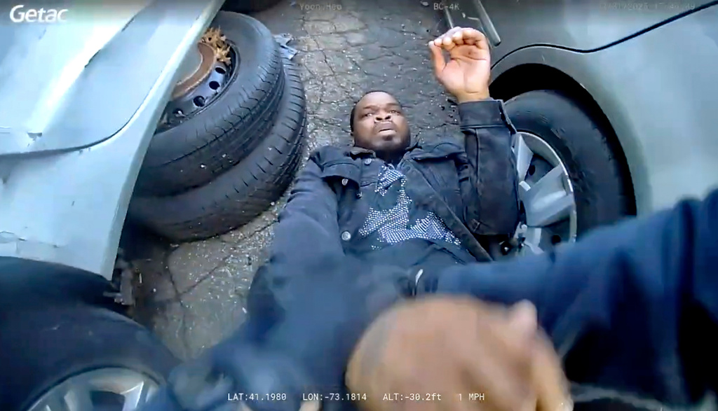 In this photo taken from video released by the Bridgeport Police Department, Dyshan Best looks up at Bridgeport Police officer Yoon Heo after being shot by Heo during a chase, Monday, March 31, 2025, in Bridgeport, Conn. (Bridgeport Police Department via AP)