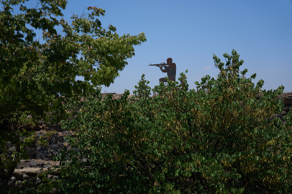 A metal board in the shape of a gunman sits on an old bunker at an observation point on Mount Bental in the Israeli-occupied Golan Heights, Tuesday, July 21, 2026. (AP Photo/Ariel Schalit)