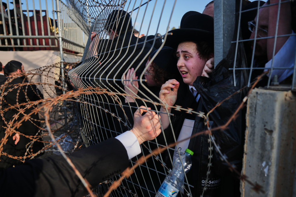 Ultra-Orthodox Jewish men protest against military recruitment and call for the release of detained draft resisters outside a military prison near Kfar Yona, Israel, Wednesday, June 17, 2026. (AP Photo/Ariel Schalit)