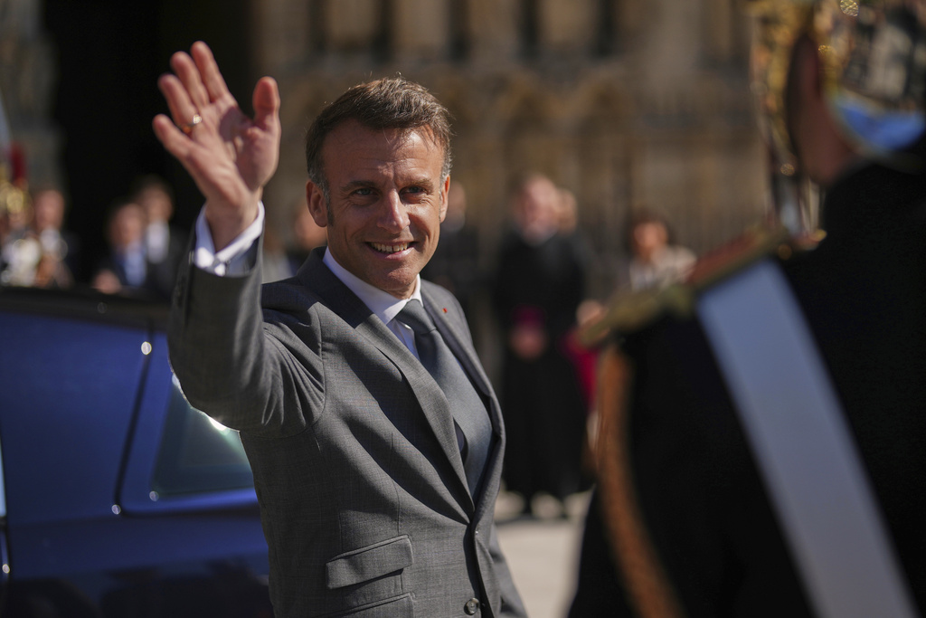 FILE - French President Emmanuel Macron waves after visiting Notre Dame cathedral with King Frederik X of Denmark and Queen Mary of Denmark, Wednesday, April 2, 2025 in Paris. (AP Photo/Thibault Camus, File)
