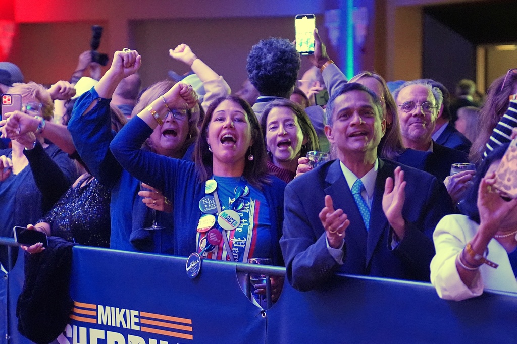 Supporters at New Jersey Democratic gubernatorial candidate Mikie Sherrill's election night party cheer as early results are seen in East Brunswick, N.J., Tuesday, Nov. 4, 2025. (AP Photo/Matt Rourke)