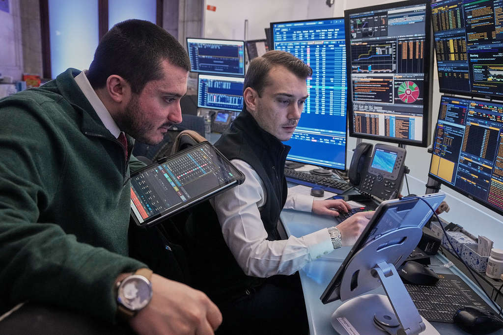 FILE - Traders Drew Cohen, left, and Dylan Halvorsan work on the floor of the New York Stock Exchange, Monday, Jan. 26, 2026. (AP Photo/Richard Drew, File)