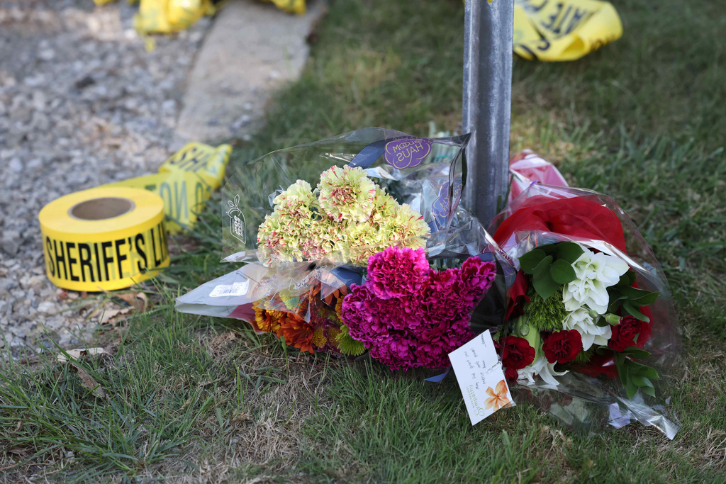 Flowers are left at a police blockade near the Church of Jesus Christ of Latter-day Saints, Monday, Sept. 29, 2025 in Grand Blanc Township, Mich. (AP Photo/Carlos Osorio)