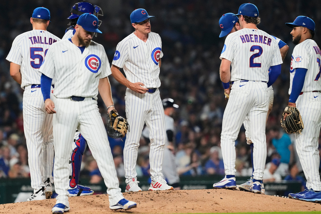 Chicago Cubs manager Craig Counsell, center, talks to players after he pulled starting pitcher Jameson Taillon, left, during the fifth inning of a baseball game against the Detroit Tigers in Chicago, Monday, July 20, 2026. (AP Photo/Nam Y. Huh)