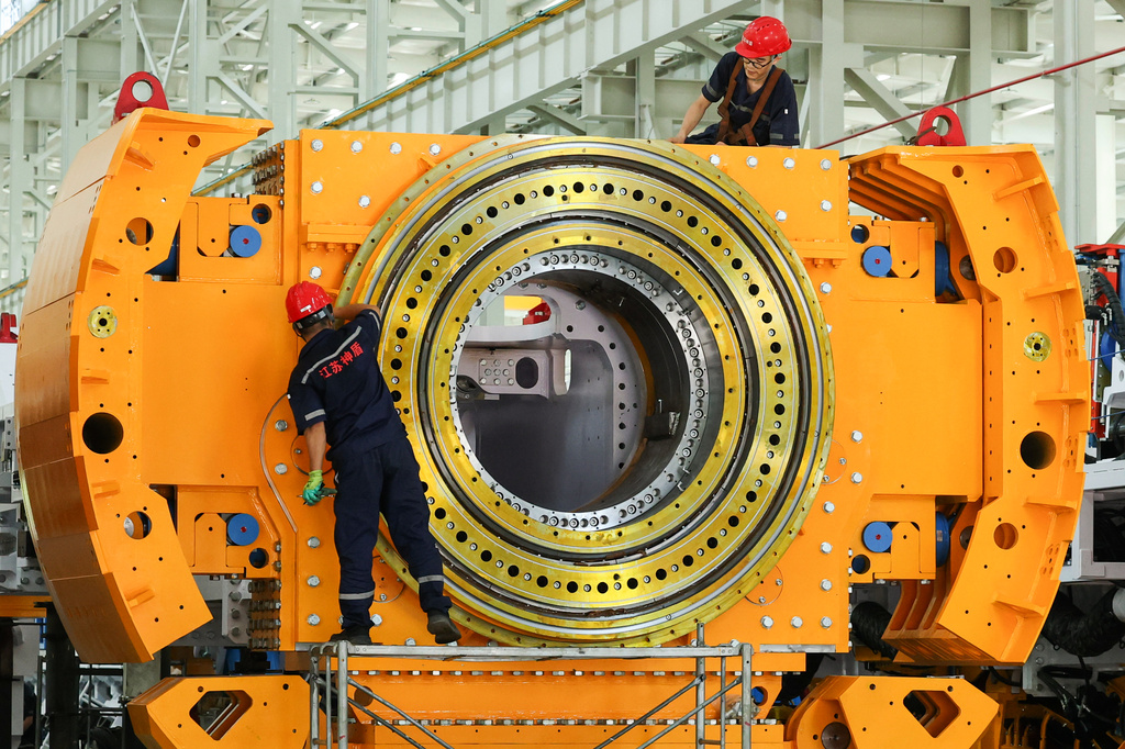 Workers install a tunnel‑boring machine at a factory in Jinhu county in eastern China's Jiangsu province on Aug. 25, 2026. (Chinatopix via AP)