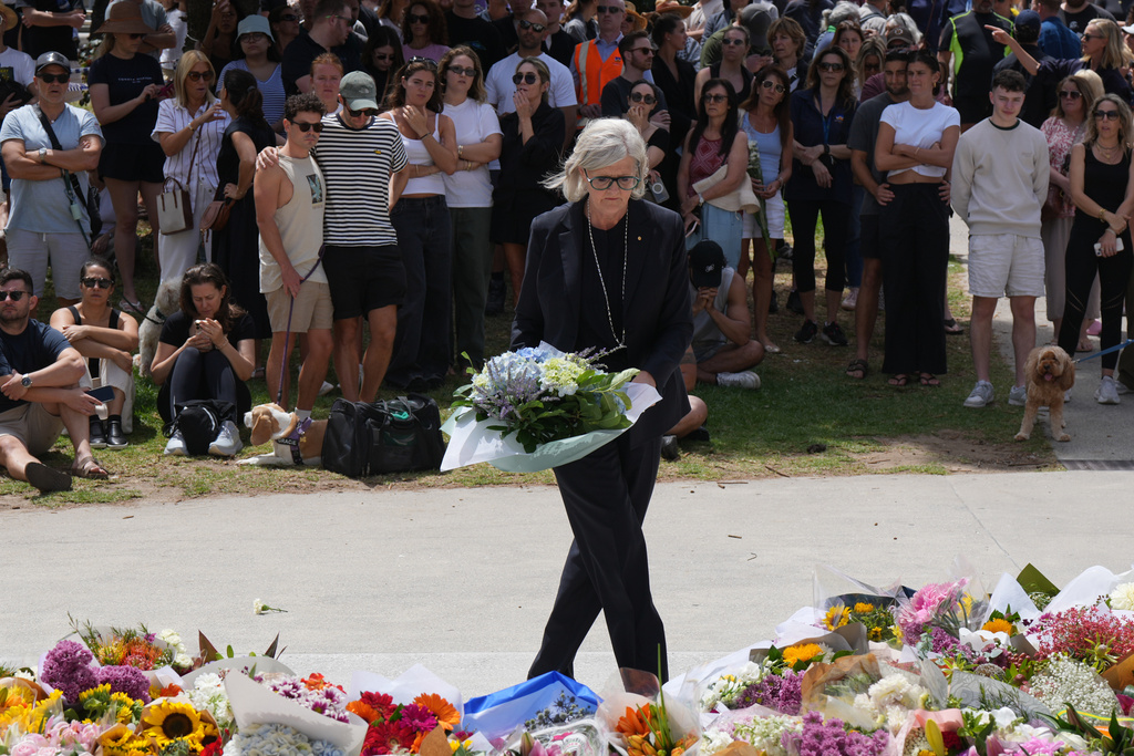 Governor General Sam Mostyn places flowers at a tribute to shooting victims outside the Bondi Pavilion at Sydney's Bondi Beach, Monday, Dec. 15, 2025, a day after a shooting. (AP Photo/Mark Baker)
