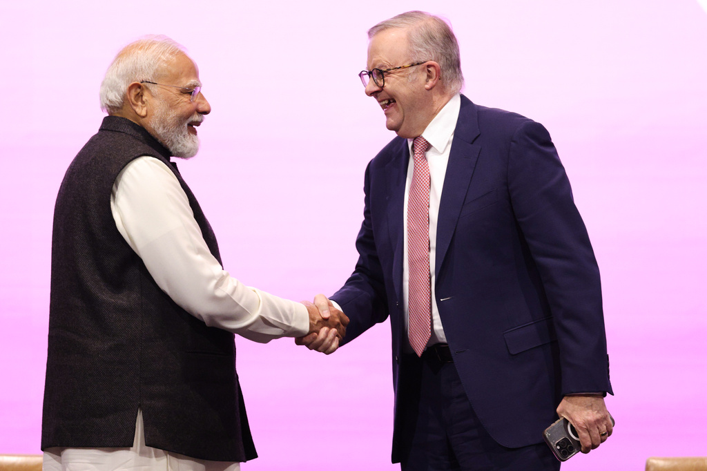 Indian Prime Minister Narendra Modi, left, is welcomed to the stage by Australian Prime Minister Anthony Albanese to address the Australia-India Economic Roadmap Business Reception in Melbourne, Australia, Thursday, July 9, 2026. (AP Photo/Hamish Blair)