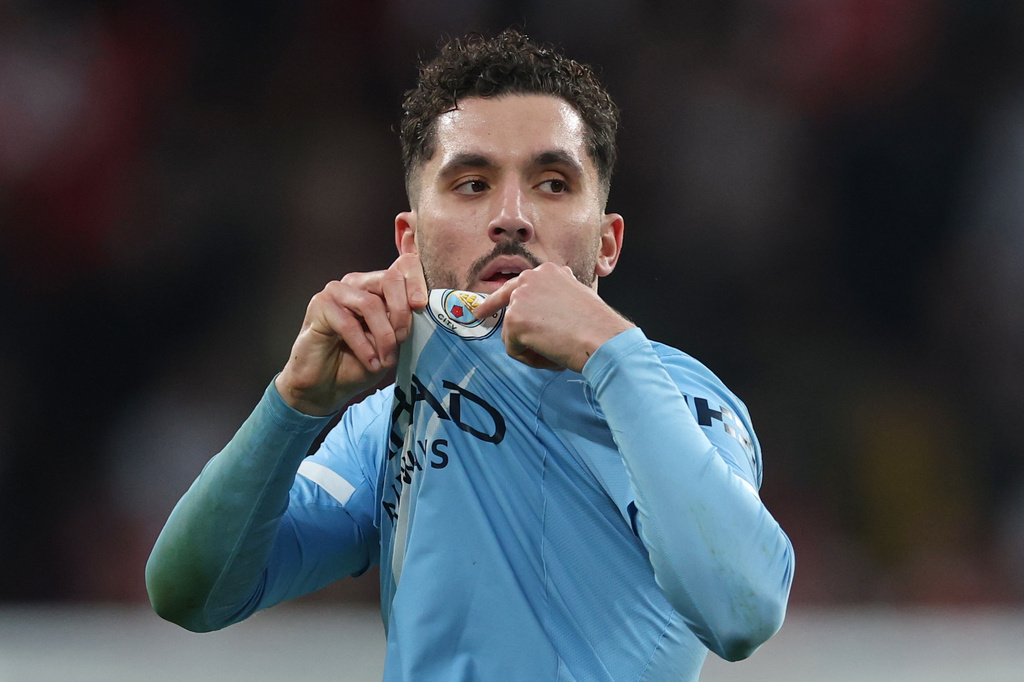 Manchester City's Rayan Cherki points to his club badge as he is substituted during the English League Cup final soccer match between Arsenal and Manchester City in London, Sunday, March 22, 2026. (AP Photo/Richard Pelham)