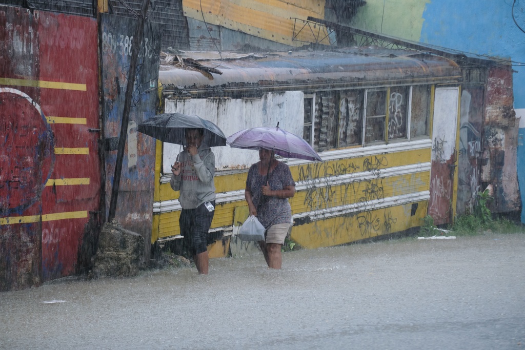 People wade through a street flooded by rains caused by Tropical Storm Melissa in Santo Domingo, Dominican Republic, Friday, Oct. 24, 2025. (AP Photo/Ricardo Hernandez) People wade through a street flooded by rains caused by Tropical Storm Melissa in Santo Domingo, Dominican Republic, Friday, Oct. 24, 2025. (AP Photo/Ricardo Hernandez)